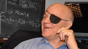 Paul sally in in front of a chalkboard