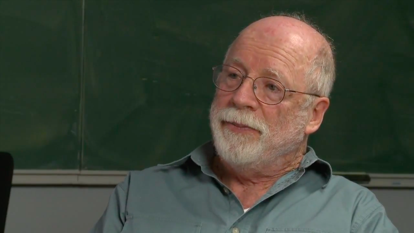 Robion Kirby in front of a chalkboard