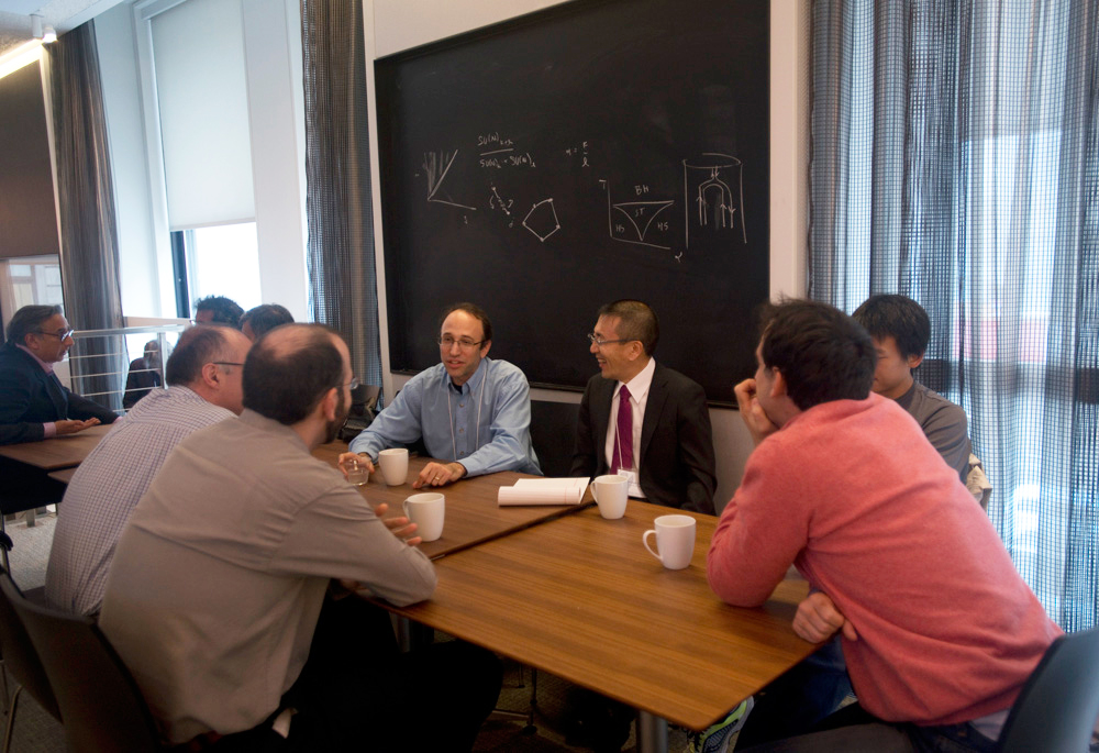 Group of people sitting at a few tables pushed together