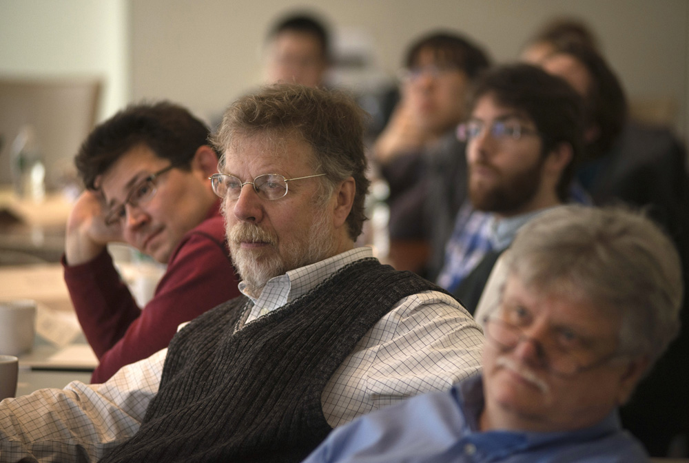 Haule, Ceperley and Hybertsen sitting at a long table next to each other