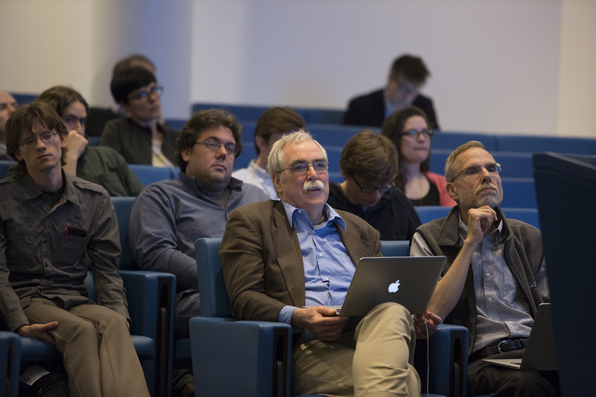 12 people sitting in a lecture hall and looking up