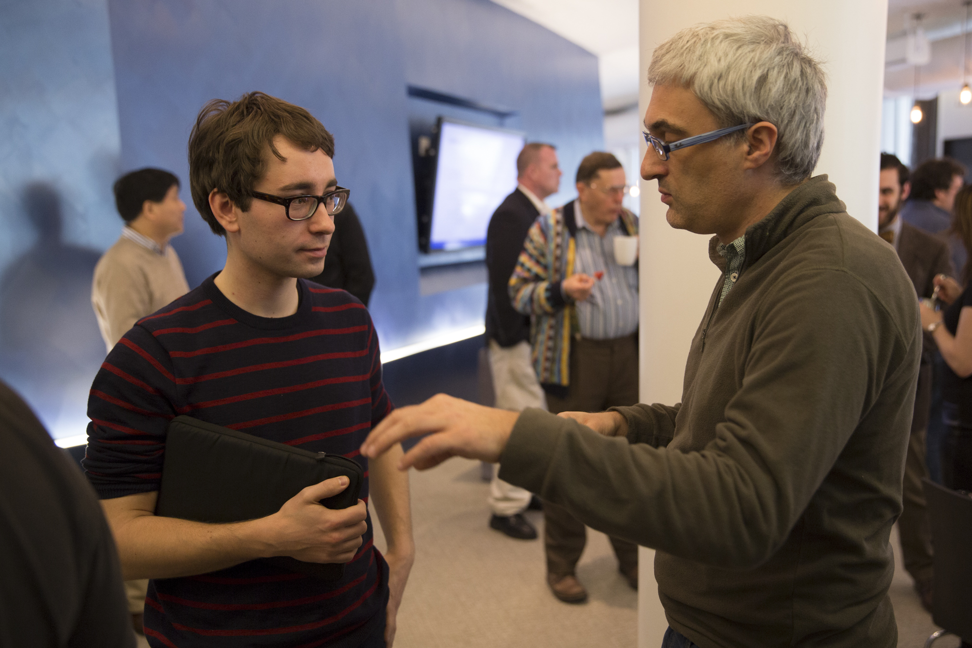 Two men standing and talking