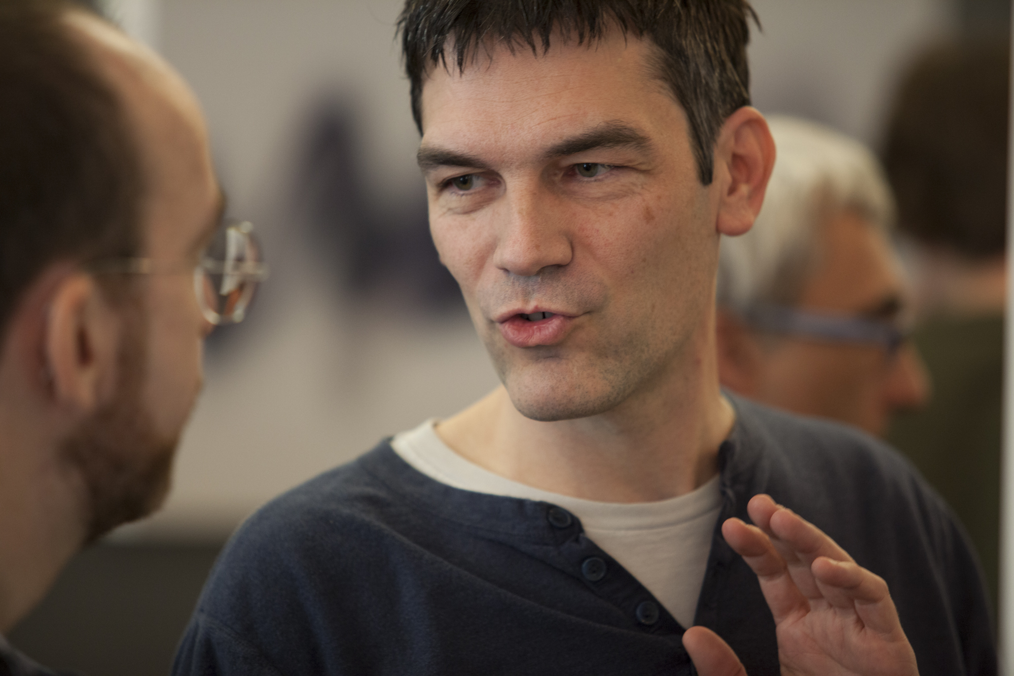 Man talking to someone to the right