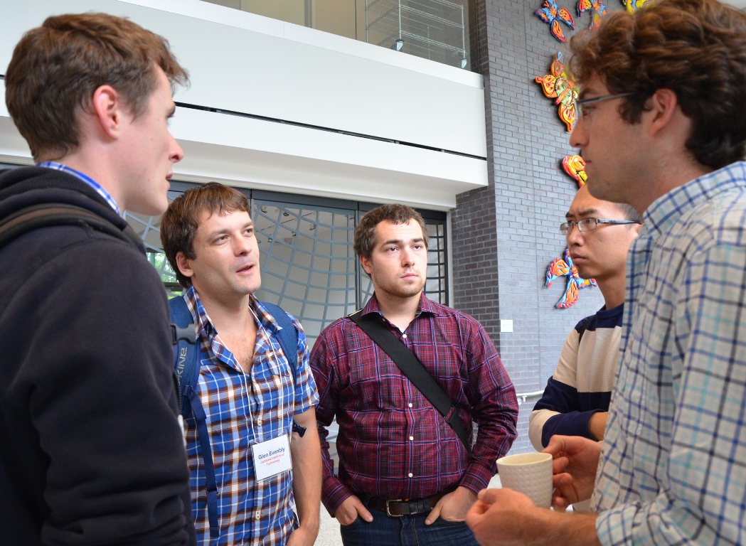 Five people standing and talking