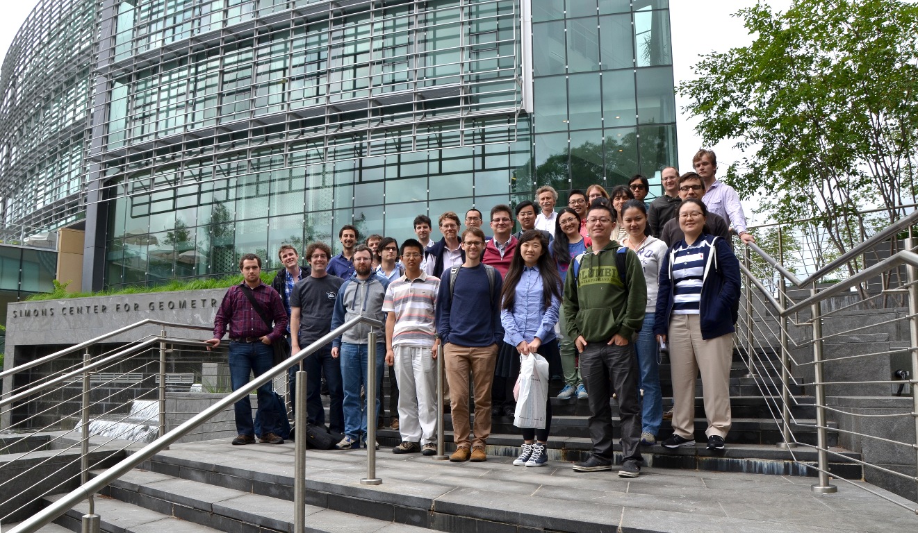 Group of people posing on steps outside the Simons Center for Geometry