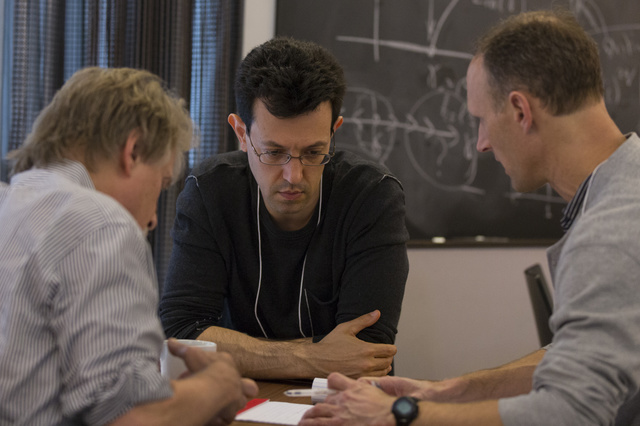 Jeff Cheeger, Assaf Naor and Bruce Kleiner collaborating at a table together