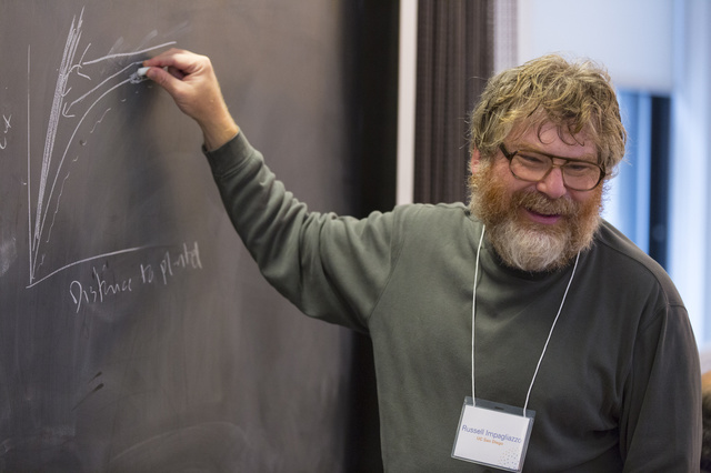 Russell Impagliazzo writing on a chalkboard