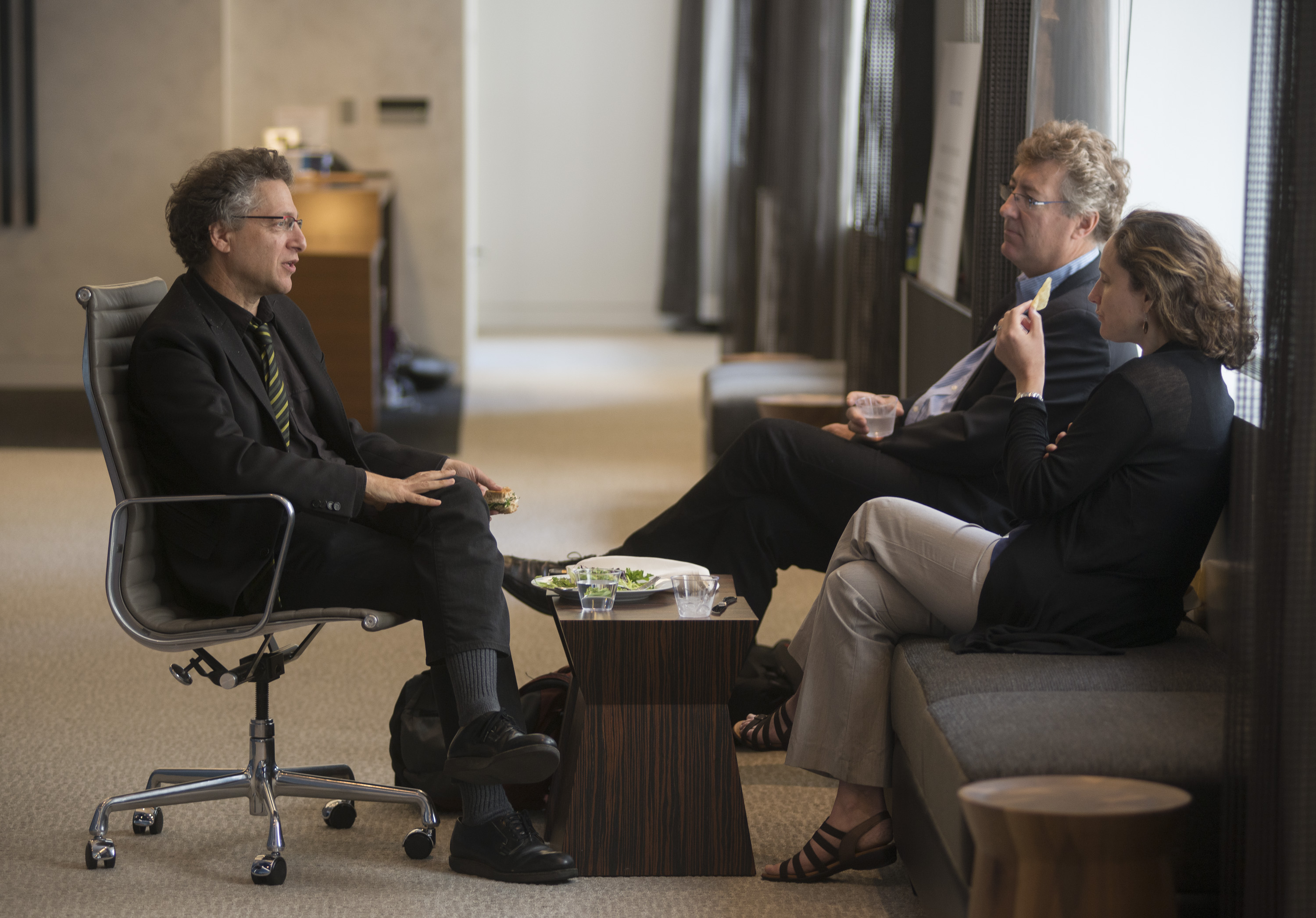 Three people sitting and talking