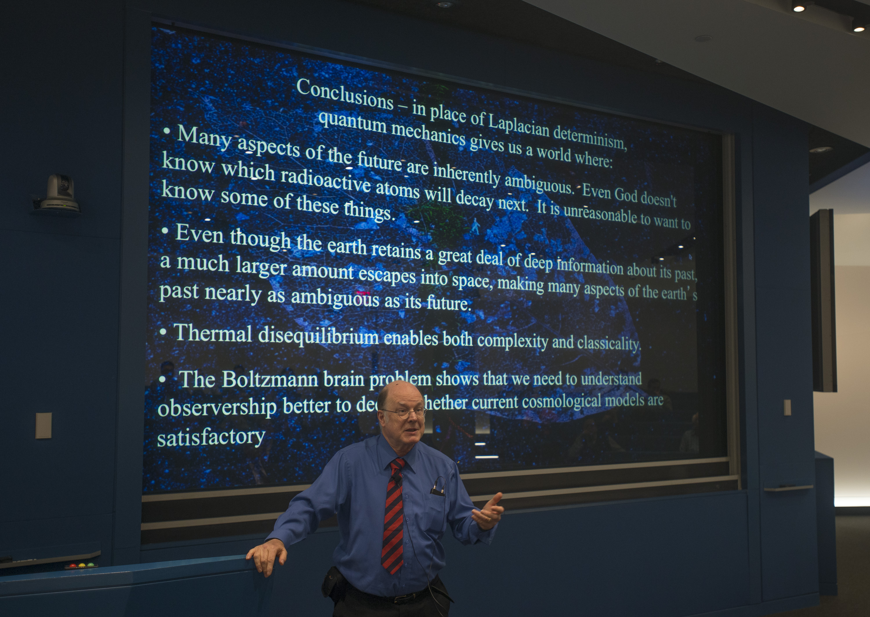 Man standing in front of a slideshow that says 