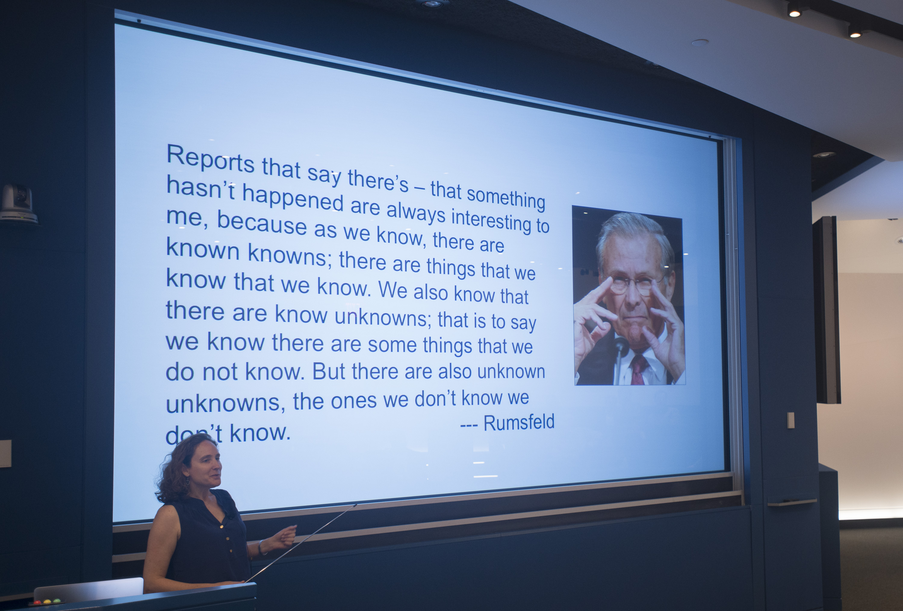 Woman presenting a slideshow that says: 