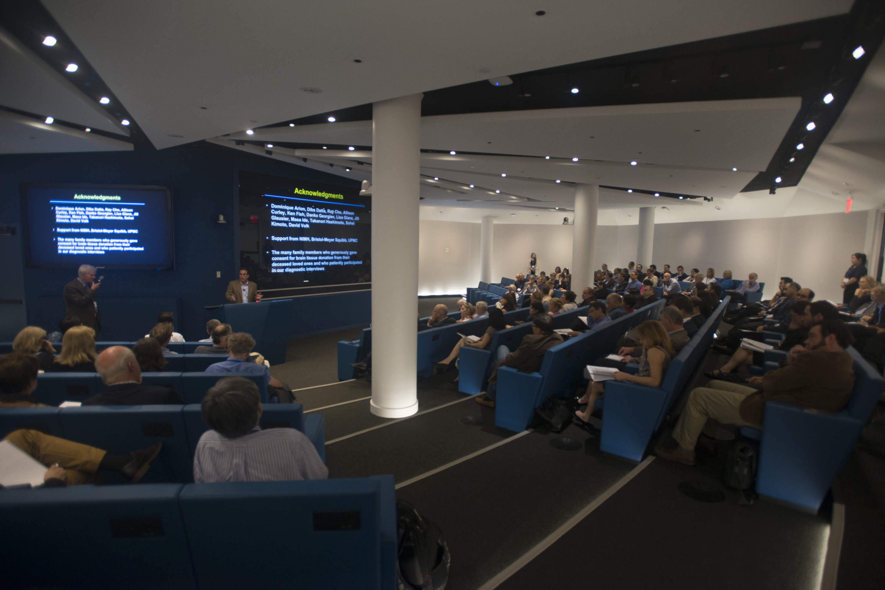 Lecture hall of people watch someone in the front