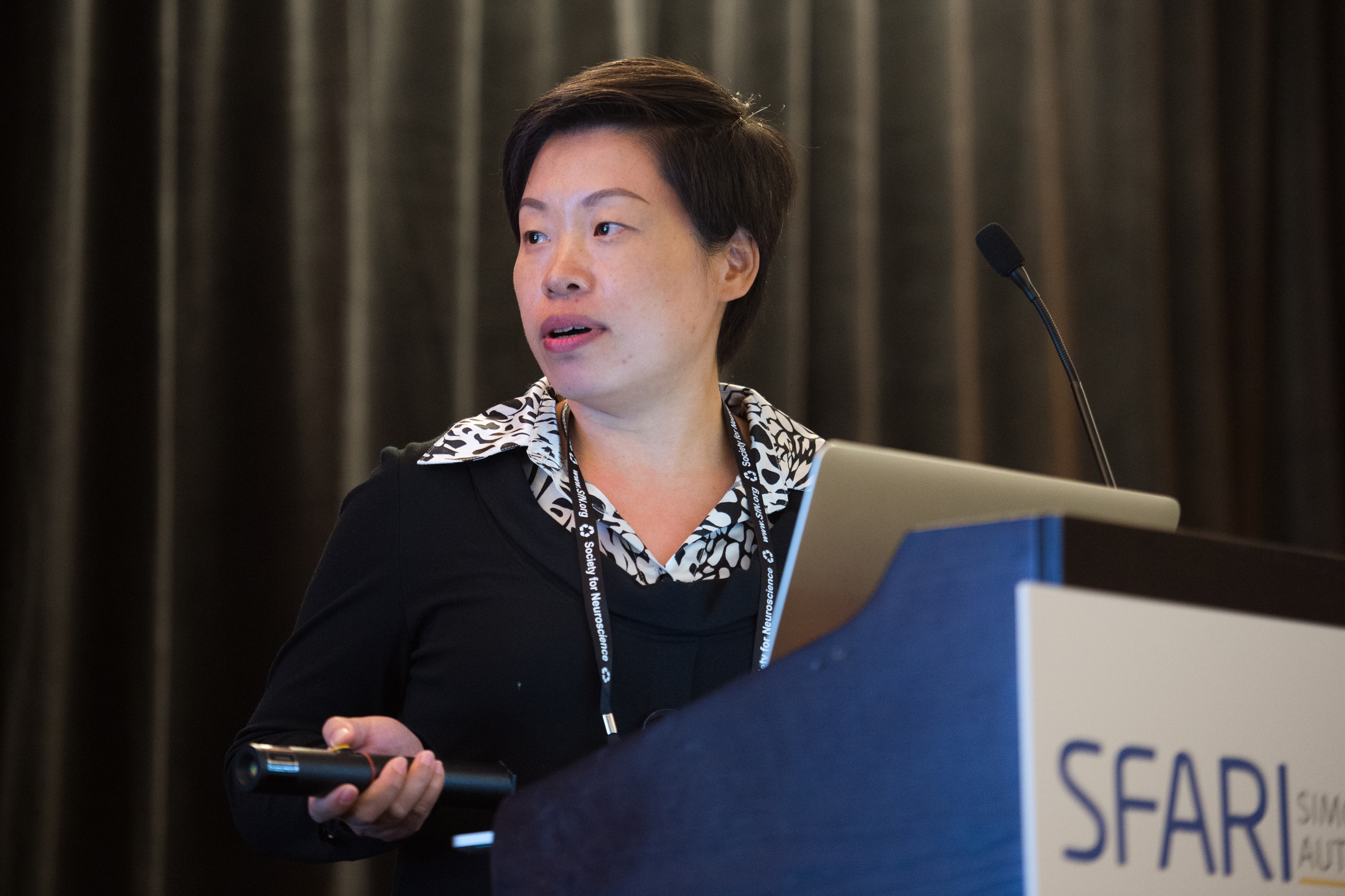 Woman speaking as she stands behind a SFARI podium