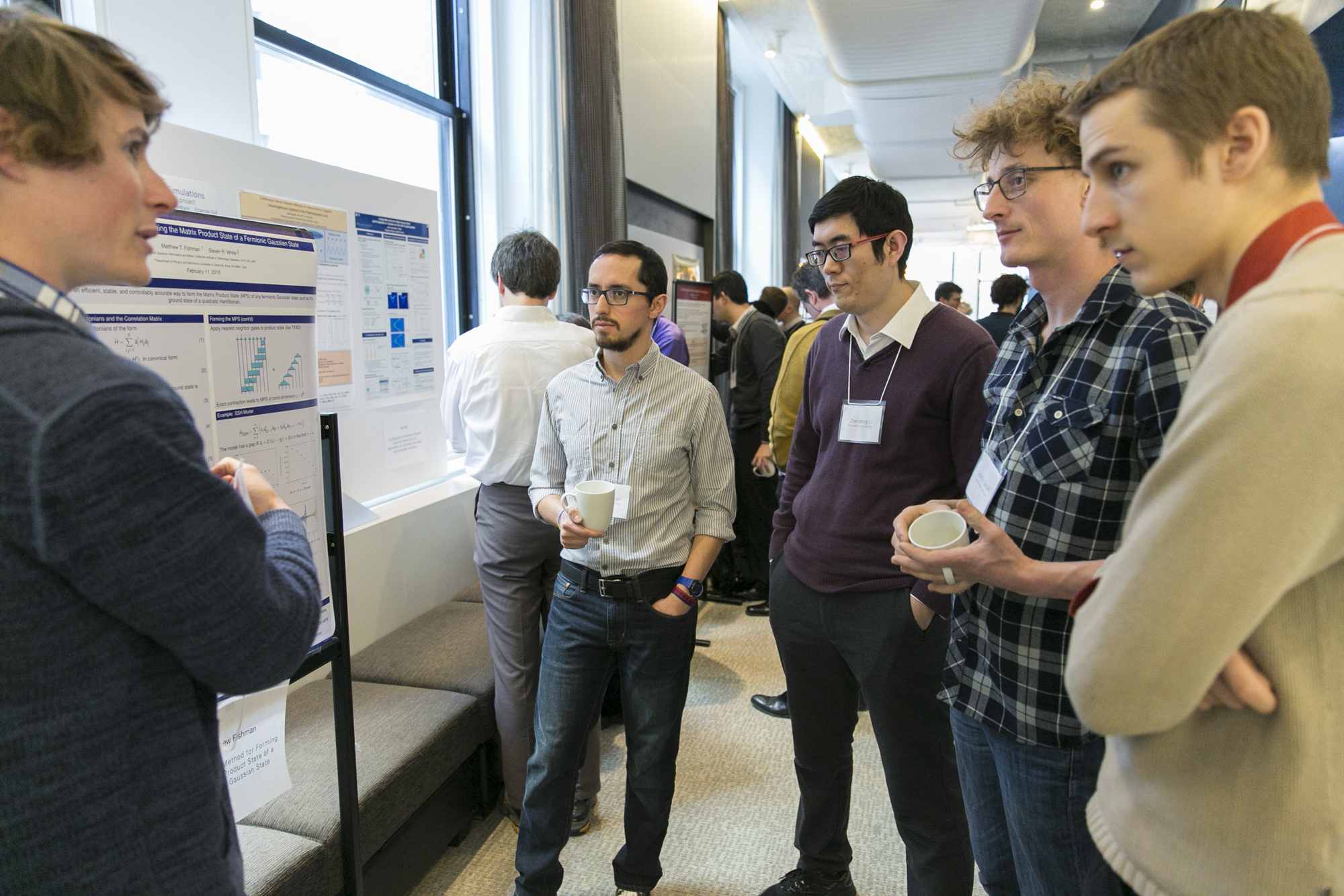 Five people standing around a presentation board