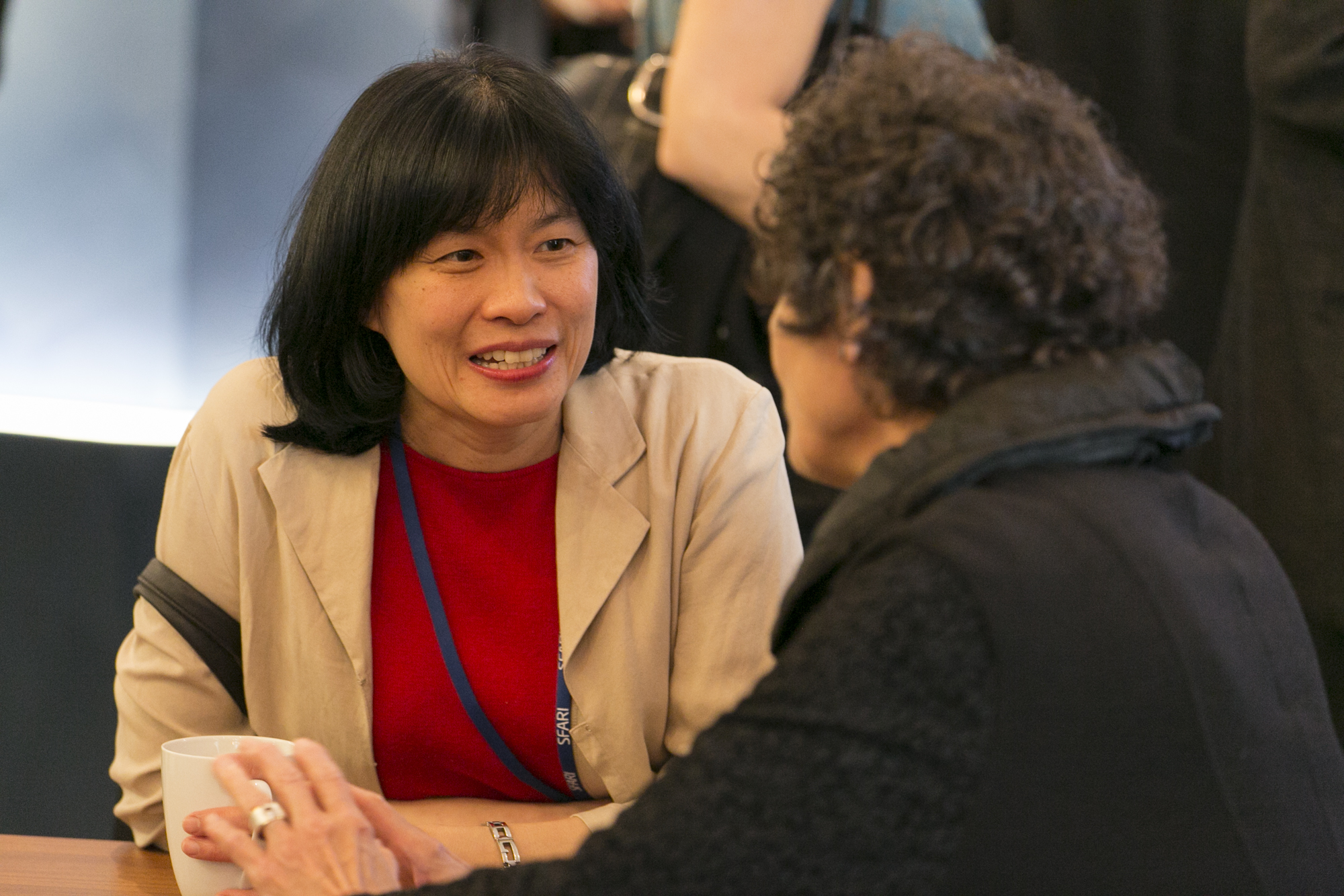Two people sitting at a table and talking