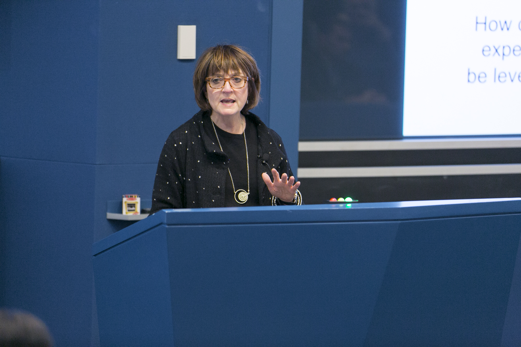 Woman talking behind a lectern