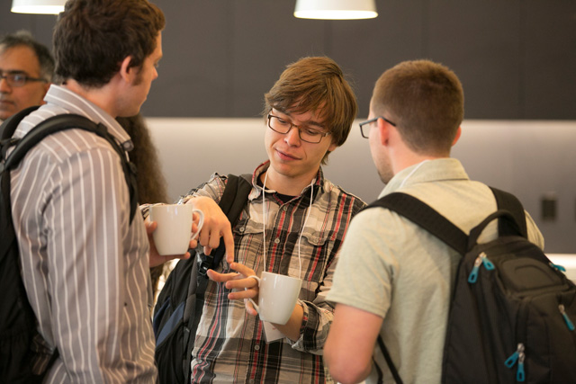 Three people standing and talking