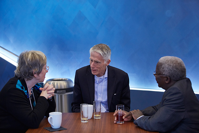 Three people sitting at a table together