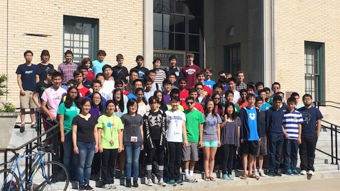 Large group of people posing on stairs