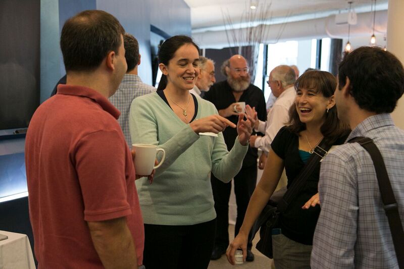 Group of four people standing and talking