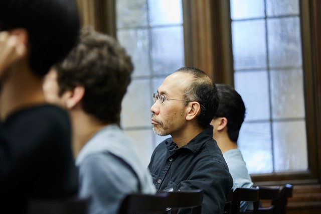 Four people sitting in a row and looking forward