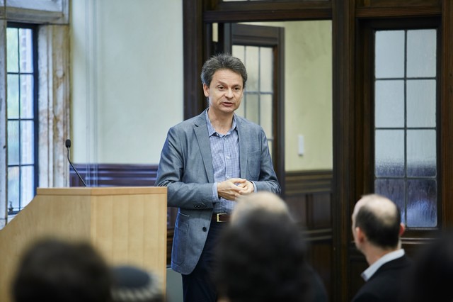 Man standing in front of a classroom of people sitting
