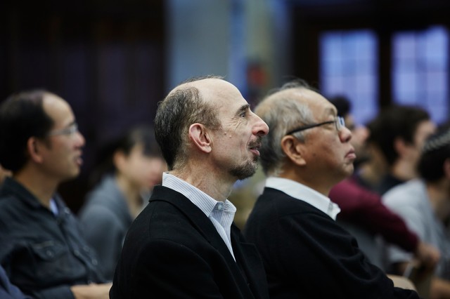 Two people sitting and looking forward and up