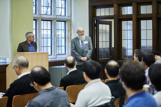 Two men standing in front of a classroom full of people