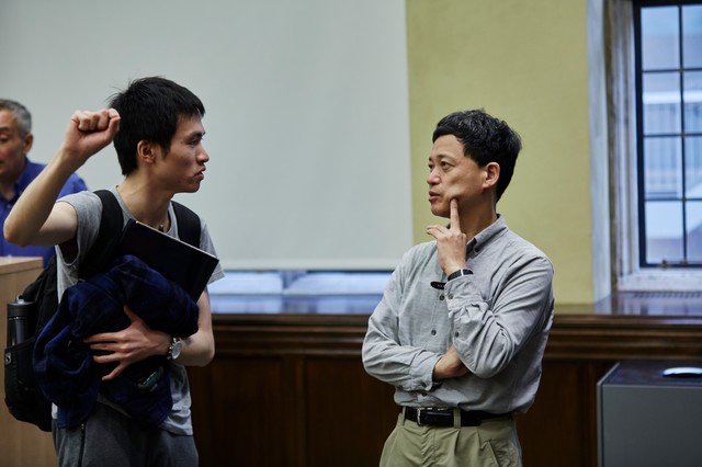 Two men standing and talking