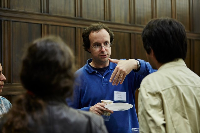 Three people standing and talking