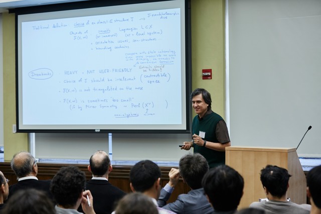 Man presenting a slideshow to classroom of people