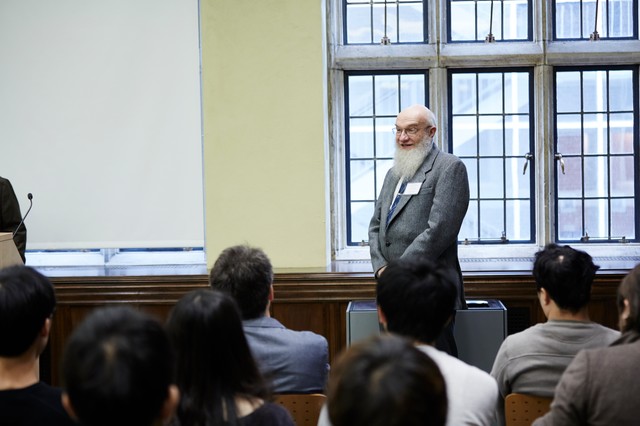 Man standing in front of roomful of sitting people