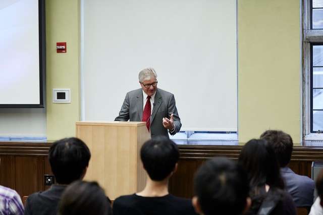 Man standing behind a lectern and talking