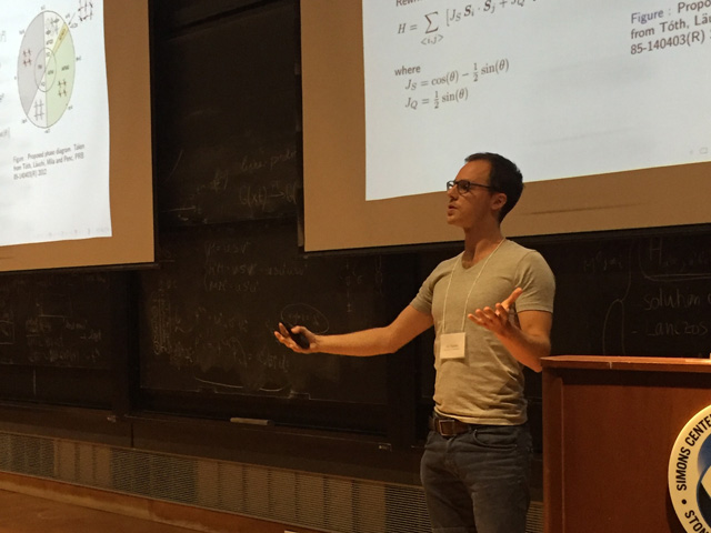 Man standing while presenting a slideshow