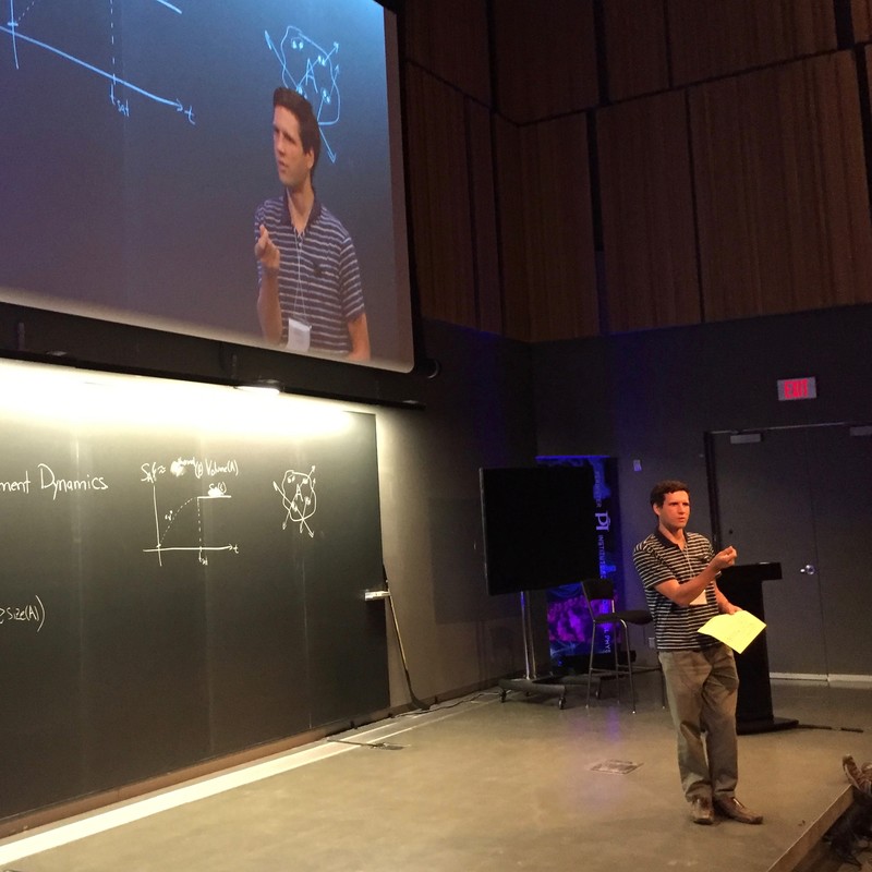 Man standing and talking with a piece of paper in his hand