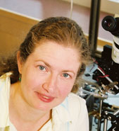 Rachel Wilson in front of a microscope