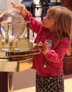 Girl touches a clear sphere