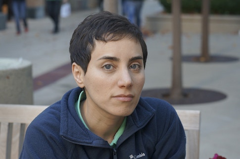 Maryan Mirzakhani sitting on a bench outside