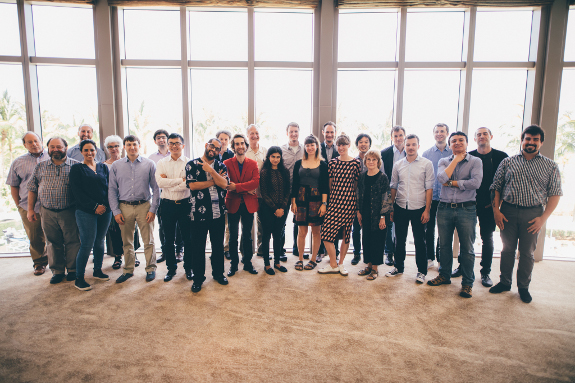 25 people standing together and posing for a photo
