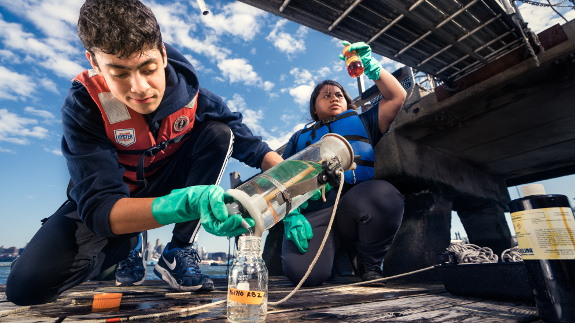 Two students inspecting water