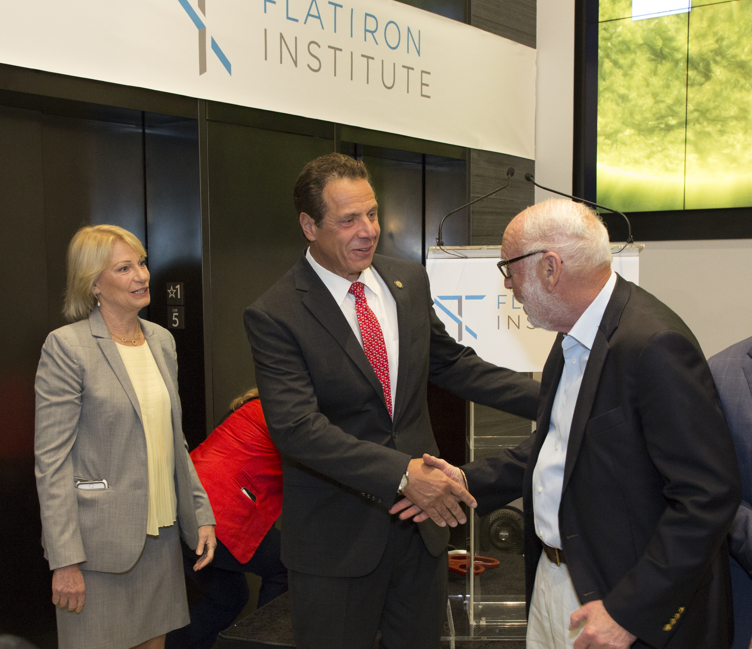 Gov. Andrew Cuomo (center) meets with Jim and Marilyn Simons during the Flatiron dedication ceremony