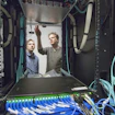 Two people working on machinery