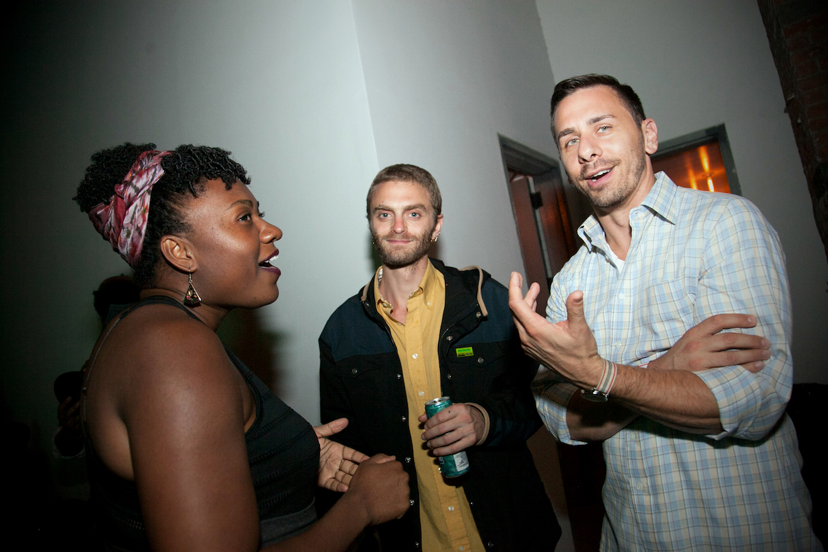 People stand and talk in the crowd of SciCon