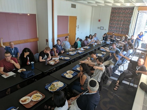 Overhead shot of people sitting on both sides of a long table