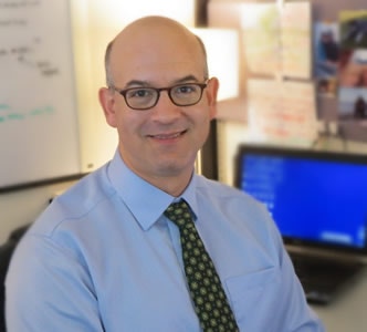 Matthew Siegel in front of a computer