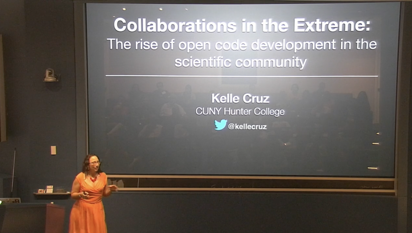 Kelle Cruz standing in front of a slideshow titled Collaborations in the Extreme: The rise of open code development in the scientific community. Kelle Cruz, CUNY Hunter College @kellecruz