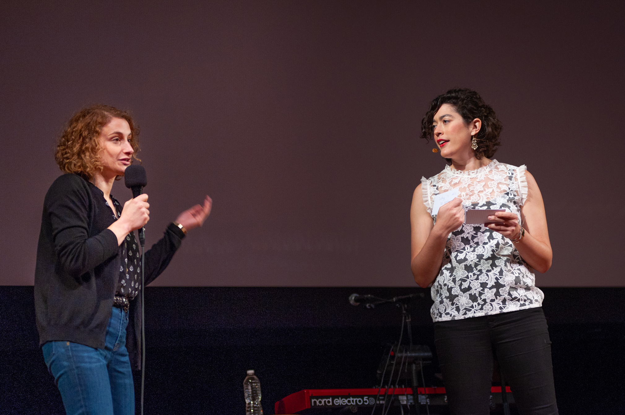 Two women standing on stage at Radiolab's 