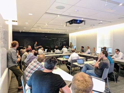 Astrophysicists Yuri Levin and Eliot Quataert lead a discussion during a meeting on the plasma physics of neutron star mergers