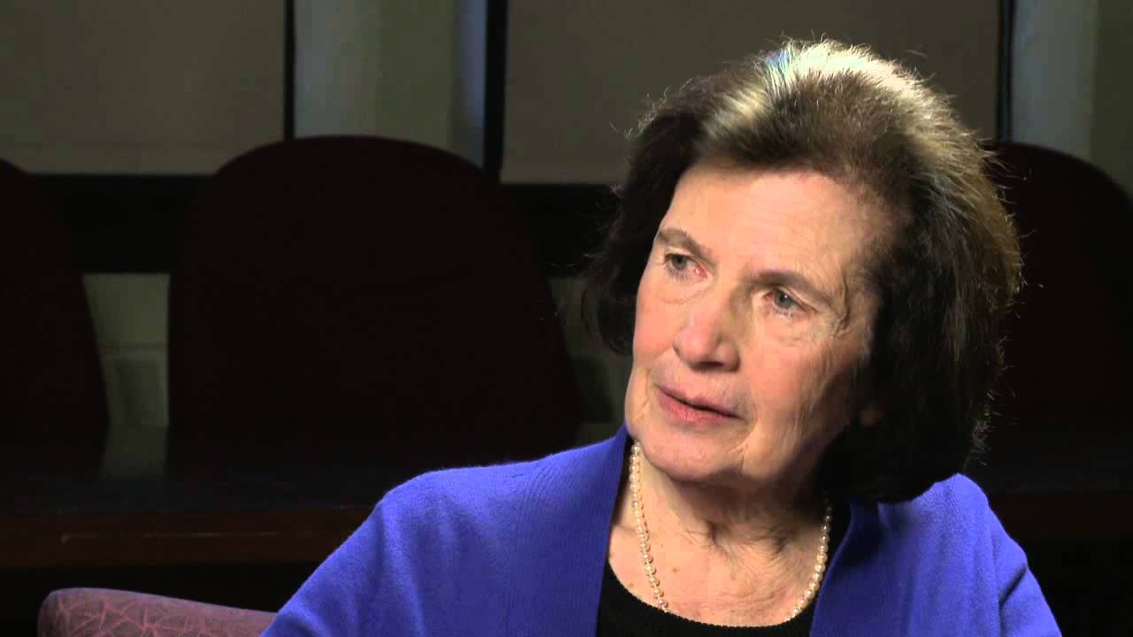 Vera T. Sós sitting and talking in a lecture hall