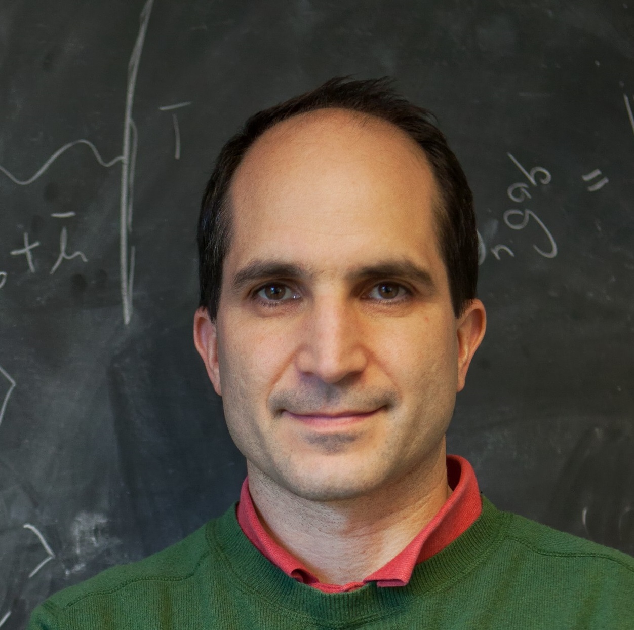 Juan Maldacena in front of a chalkboard