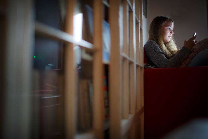 A woman looking at a smartphone screen